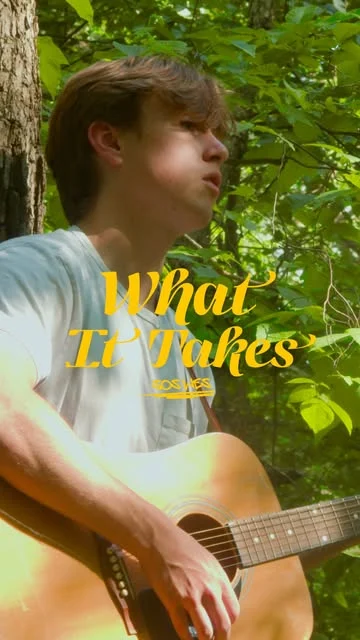 Charlie playing guitar outdoors for What It Takes